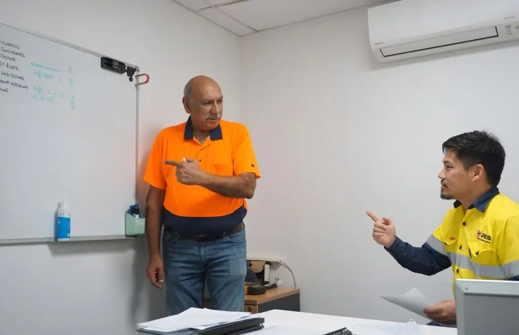 HSEQ consultant conducting workplace safety and WHS compliance training with a worker in Perth